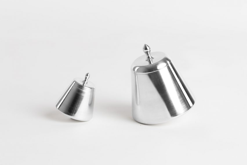 a photograph of two silver trapezium-shaped objects against a white backdrop
