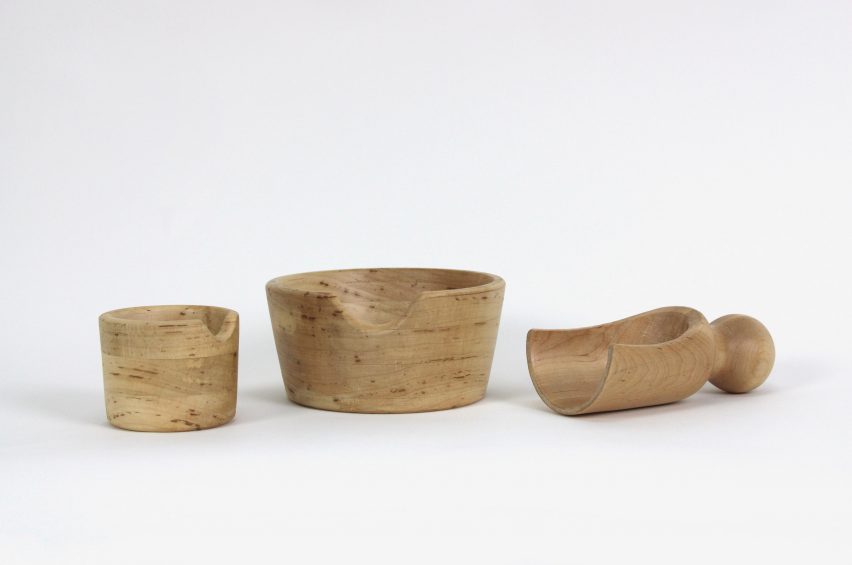 a photograph of a set of wooden vessels pictured against a white backdrop