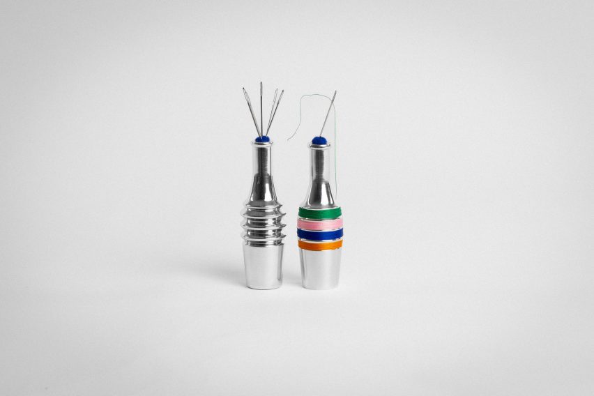 a photograph of two silver bottles. One has coloured thread wrapped around it in tones of orange, blue, pink and green