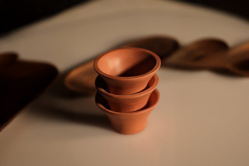 a photograph of brown ceramic pots in a pile