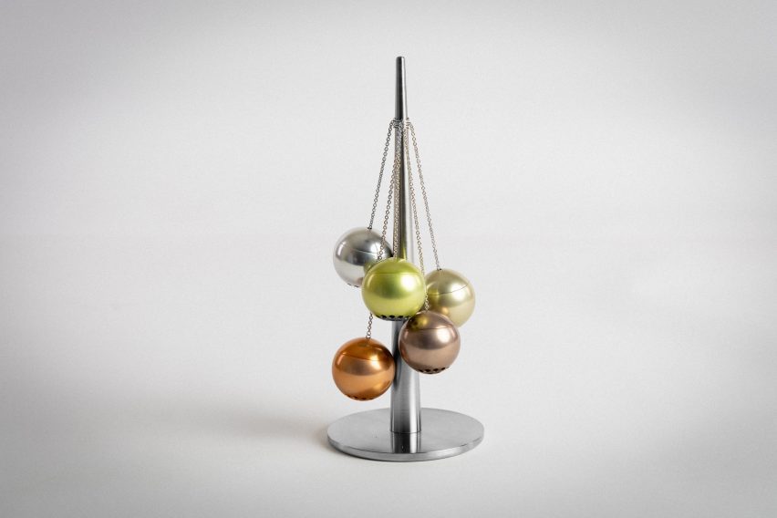 a photograph of a silver ornament in tones of orange and green