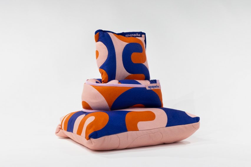a photograph of a pile of cushions in colours of orange, blue and pink