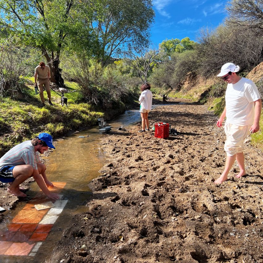 a photograph of people on a river bank