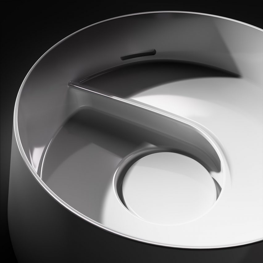 Close-up image of a circular white washbasin with a spiral interior shape and a large covered water outlet