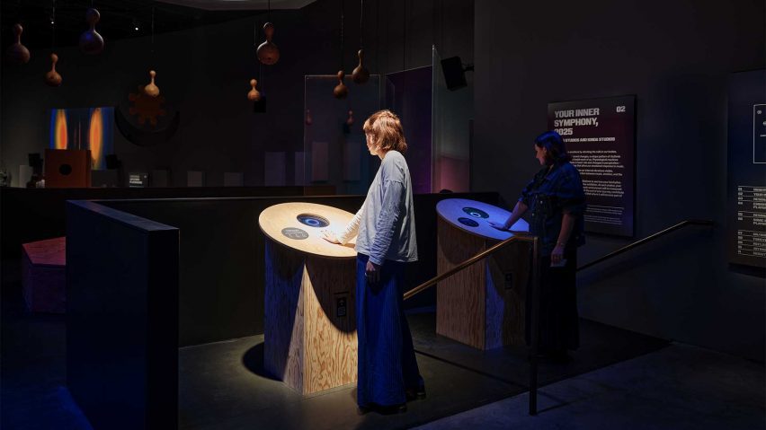 Visitors interacting with touchpoints within the exhibition