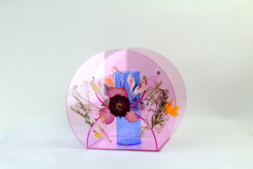 a photograph of a small vase in a circular form, in tones of pink and blue with floral patterns on it