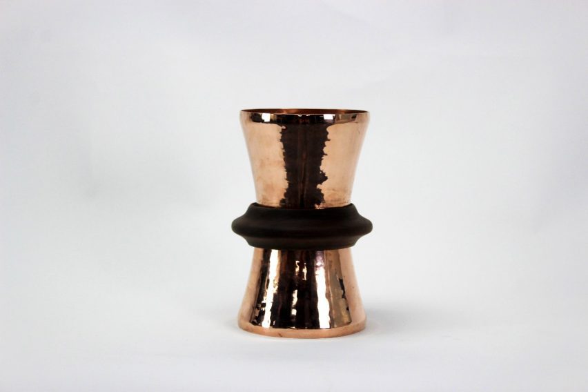 a photograph of a lamp made of copper against a white backdrop