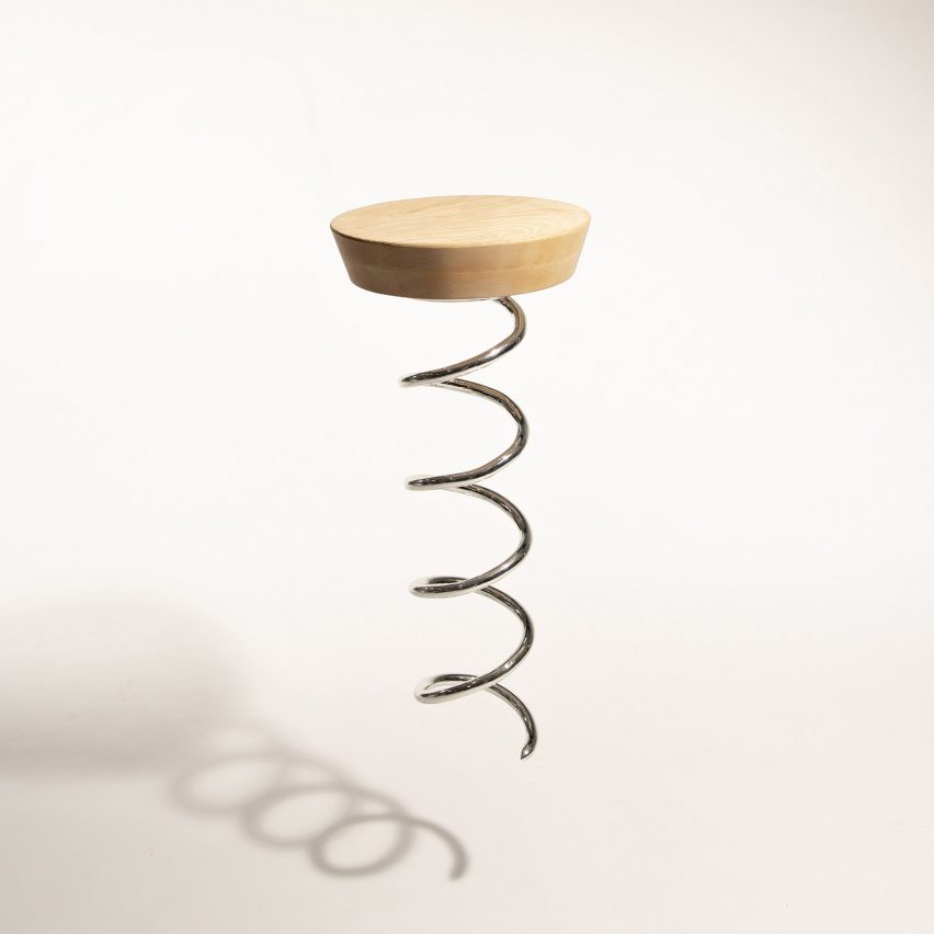a photograph of a stool design with a wooden seat and a base that is a metal screw, in the style of a corkscrew