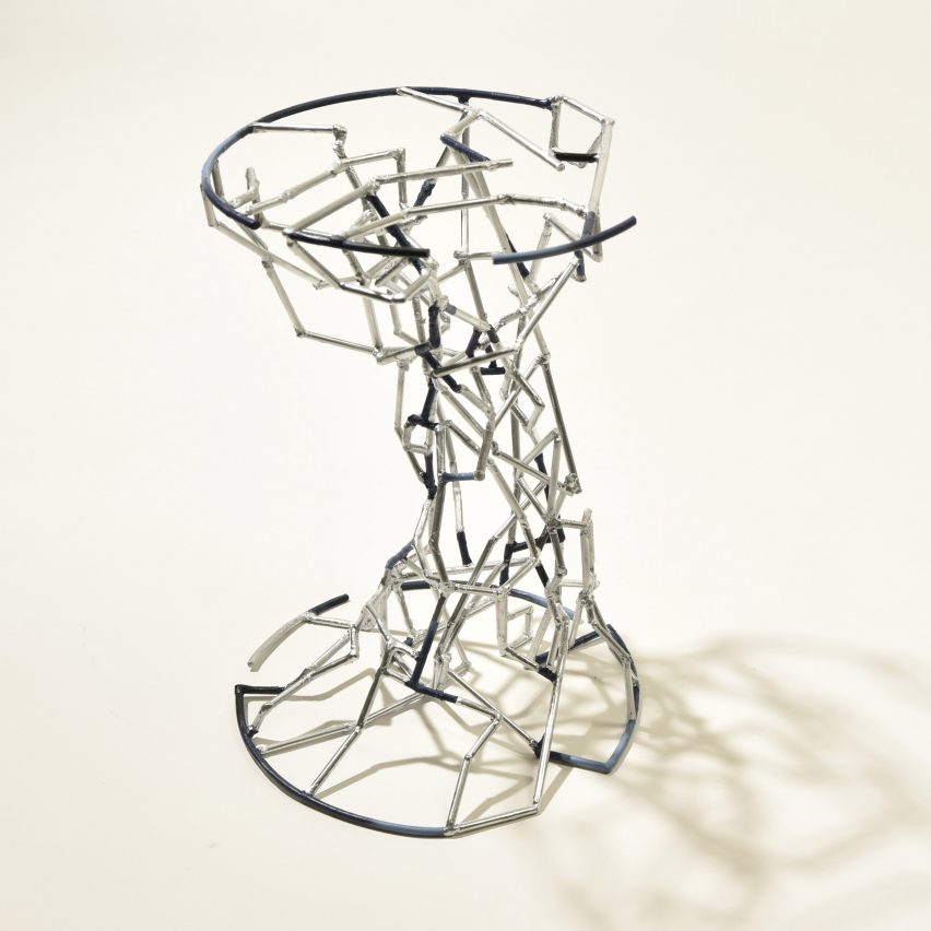 a photograph of a silver metal stool in a fragmented form