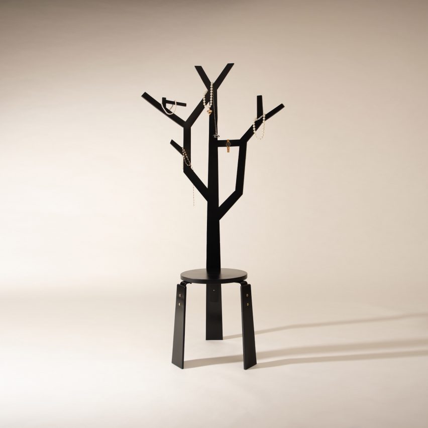a photograph of a stool design with a tree-like form coming out of it in tones of black