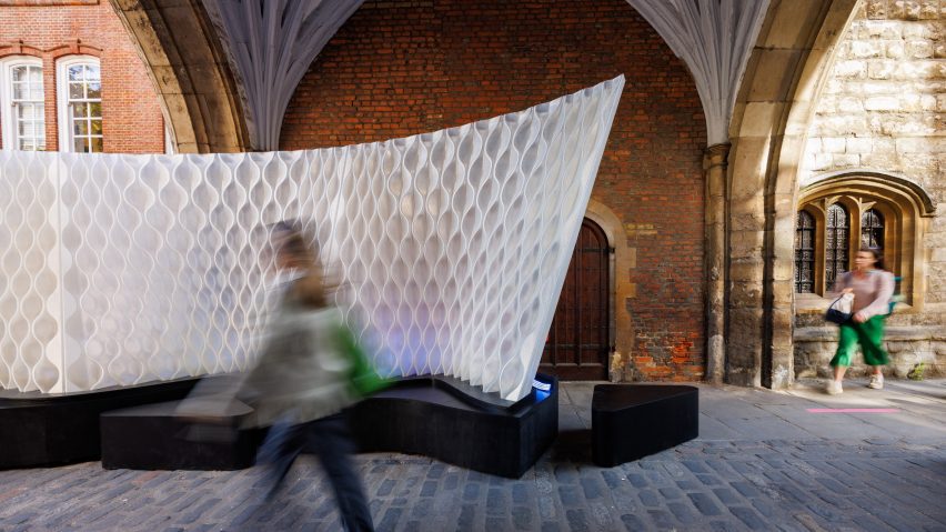 Person walking through St John's Gate archway next to Arthur Mamou-Mani's Harmonic Tides installation