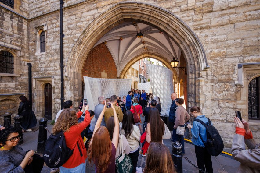 Crowds of visitors under the archway of St John's Gate looking at the installation