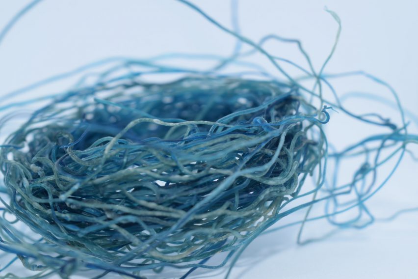 a photograph of bundled strings of materials in tones of blue