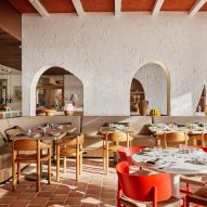 Light flooding into dining space with red chairs Cibaria restaurant