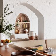 Arch cut into white stucco wall Cibaria Manly