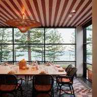 Private dining space overlooking the sea with red and white striped ceiling