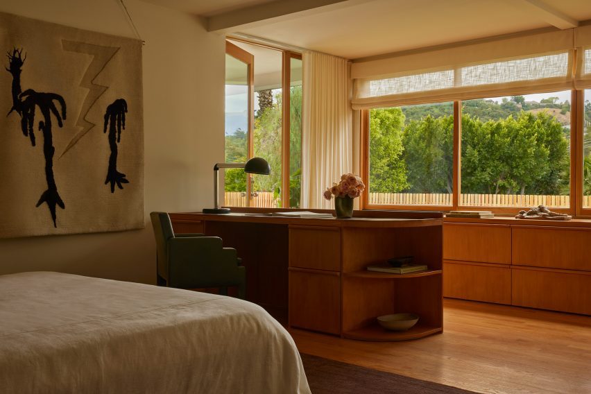 Primary bedroom with custom desk, storage and a day bed