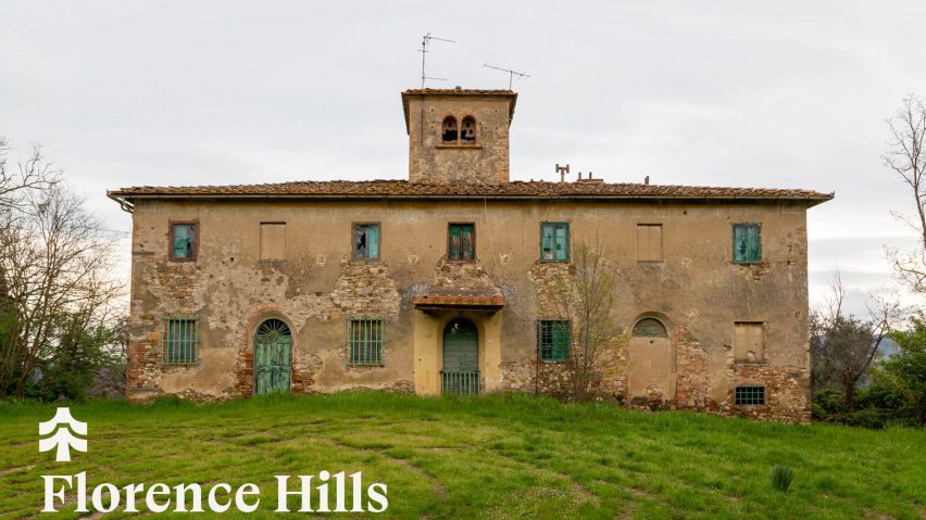 a photograph of a stone building in beige with a green lawn in front of it