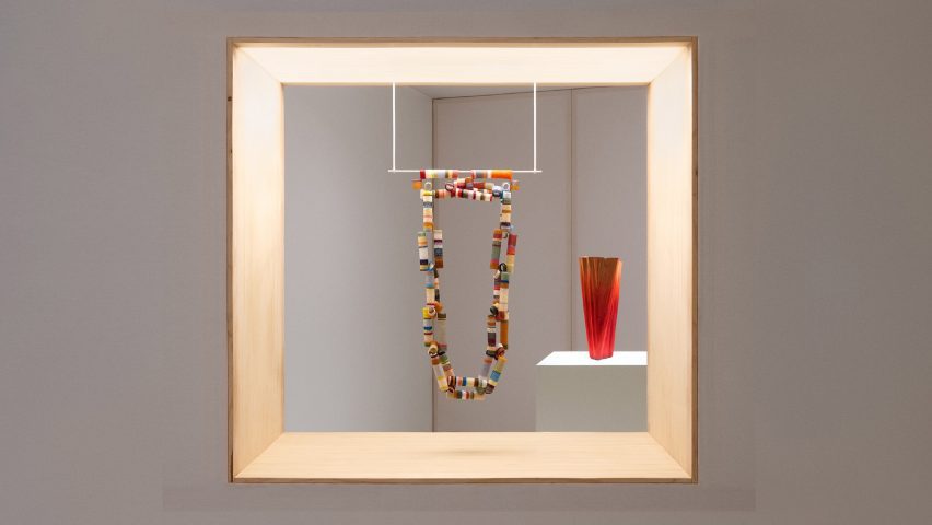 Necklace hanging in an exhibition window