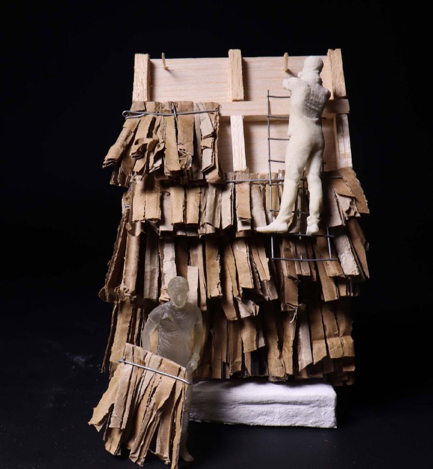 a photograph of a model of a house with cardboard pieces attached to it in tones of brown.