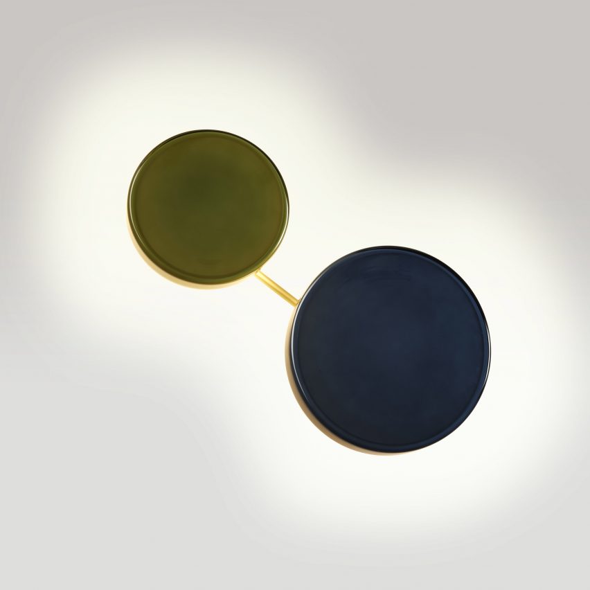 a photograph of two circular wall lights in tones of green and blue