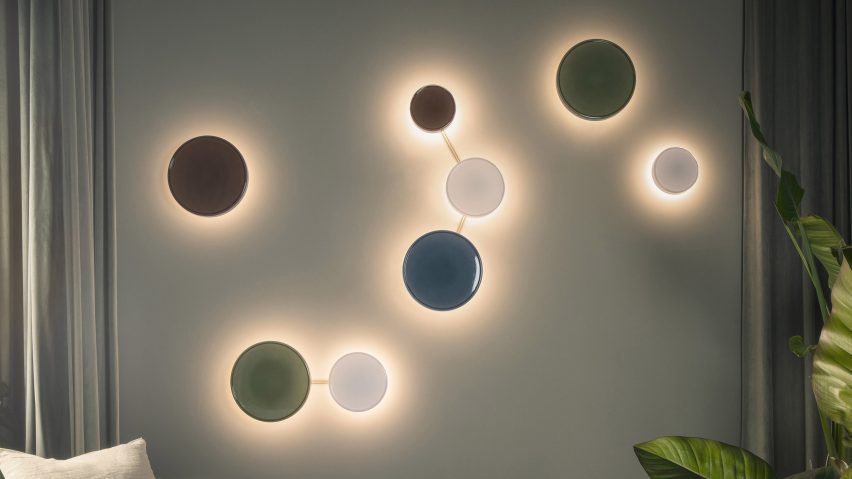 a photograph of circular coloured lights on a wall next to a sofa
