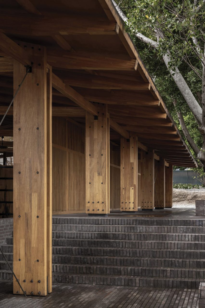 Grey brick steps below an overhanging wooden roof