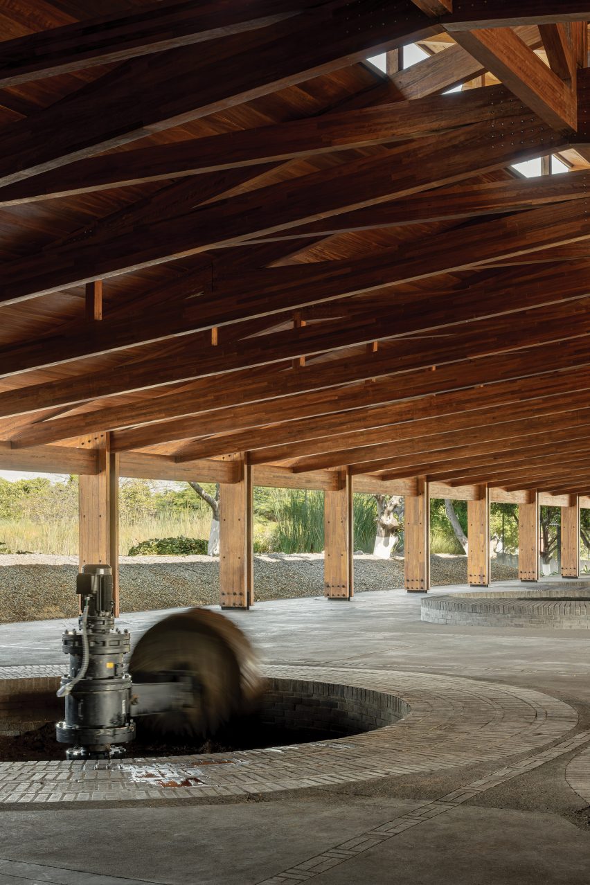 Pit for crushing agave under a wooden roof truss