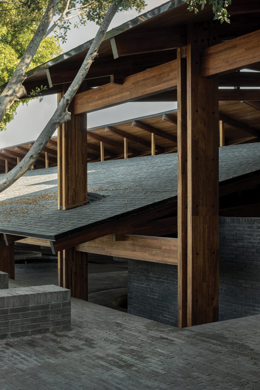 A cross-laminated timber structure supports pitched, overlapping roof planes