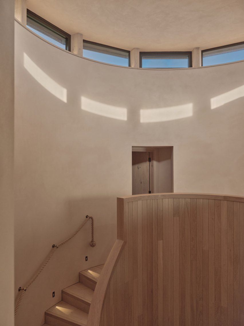Staircase with clerestory windows in Two-Family House by Rundell Associates