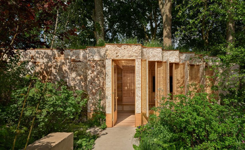 Wooden pavilion in green landscape