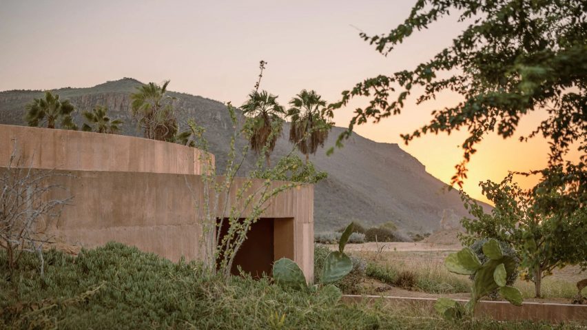Half-buried concrete spiritual enclosure