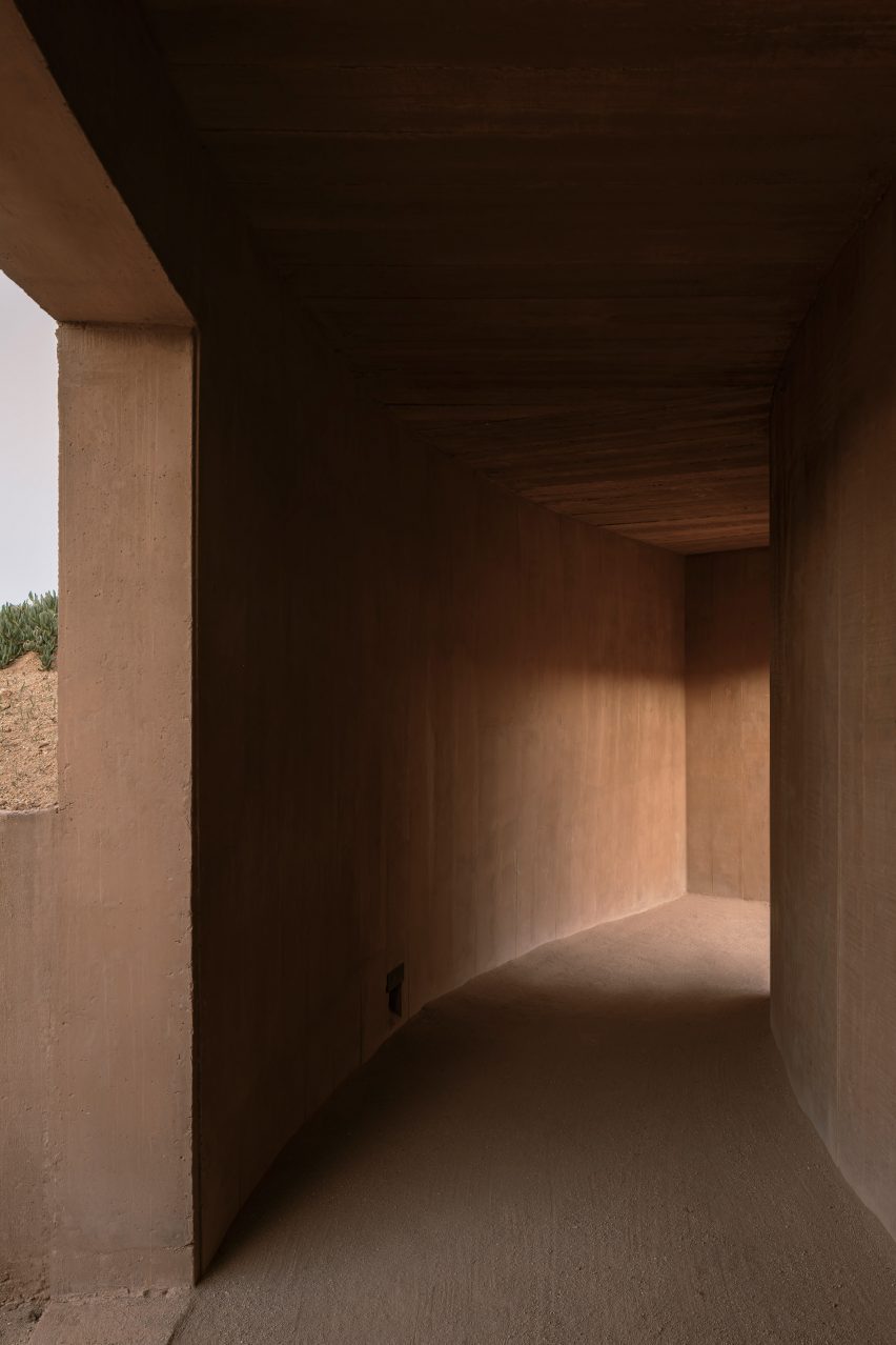 A curved corridor leading from one doorway to another