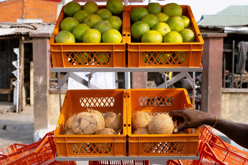 Hand reaching for a coconut inside a market stall