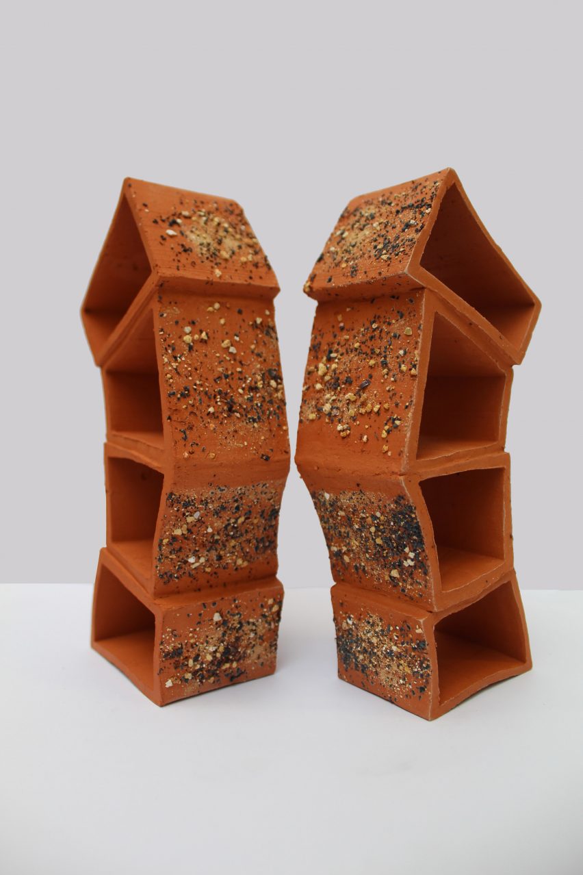 a photograph of two brown sculptures beside one another against a white backdrop