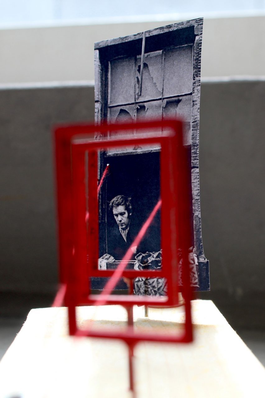 a photograph of a red frame in front of a black and white photograph