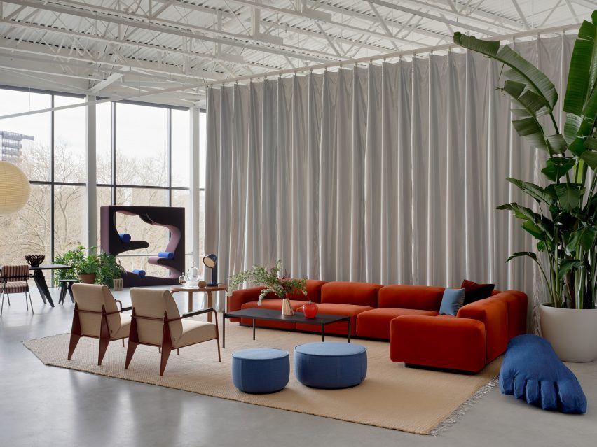 A silvery curtain acts as a backdrop for a furniture vignette