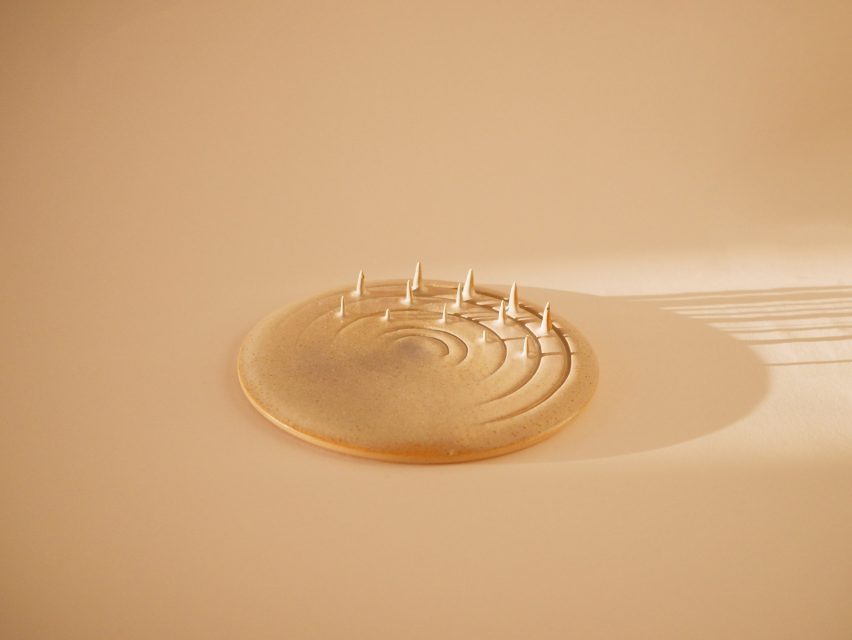Photo of a ceramic plate with grooves cut into one side and spikes rising up from in between them
