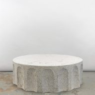 Photograph of the coffee table in the collection, which looks like a section of a classical granite column.