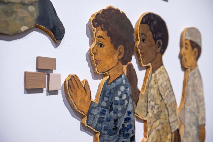 Photo of paintings of children on wood