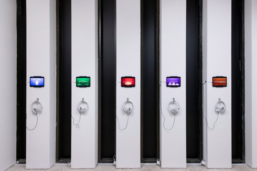 Photo of headphones and screens on narrow walls