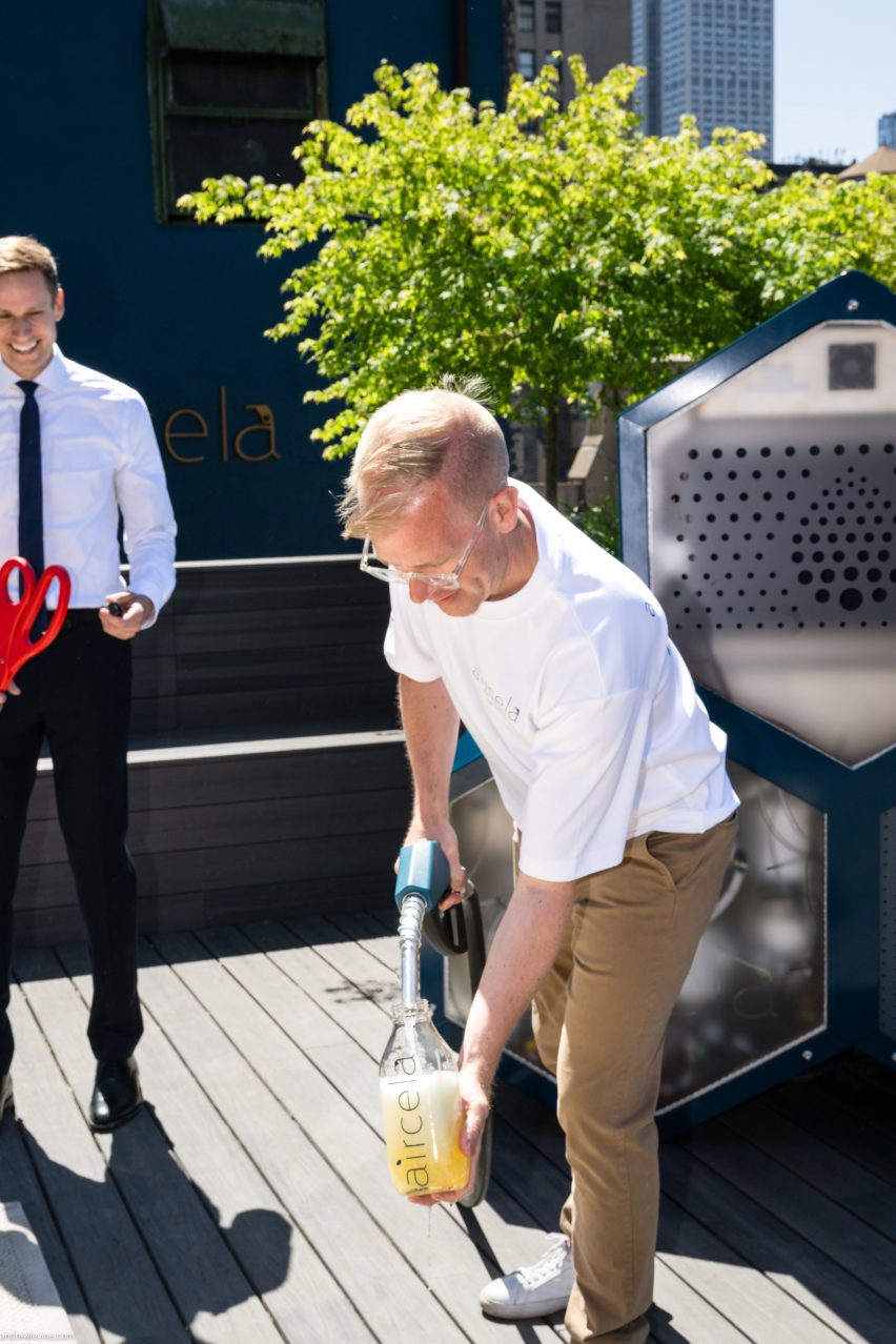 Photo of a man pouring petrol using a station-lik hand pump from an Aircela machine on a sunny rooftop