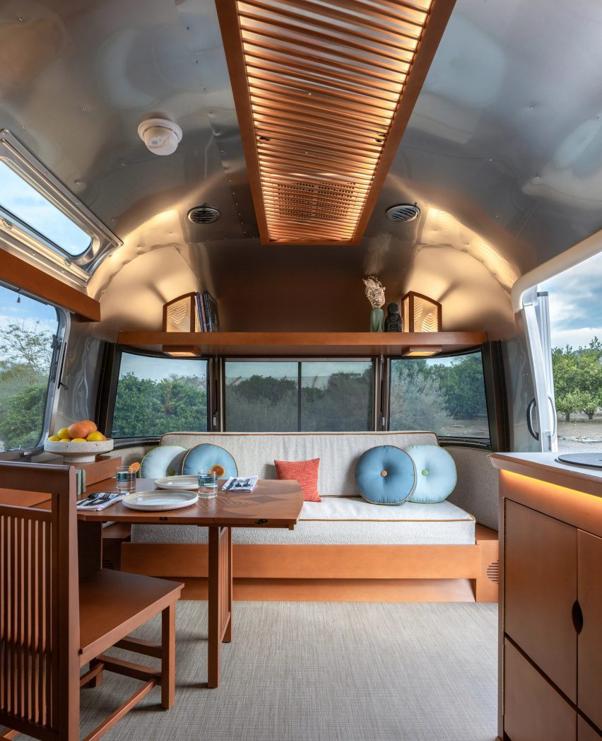 A dining area and bench inside Frank Lloyd Wright Airstream trailer