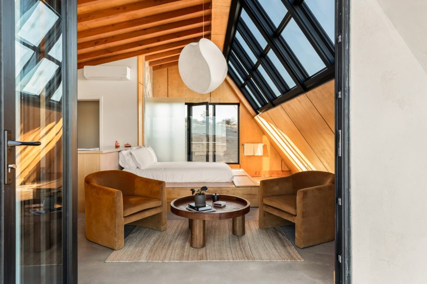Bed positioned below slanted windows for optimum stargazing