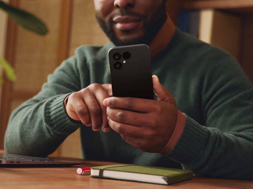 Photo of a calm-looking man using the Fairphone 6 in close-up