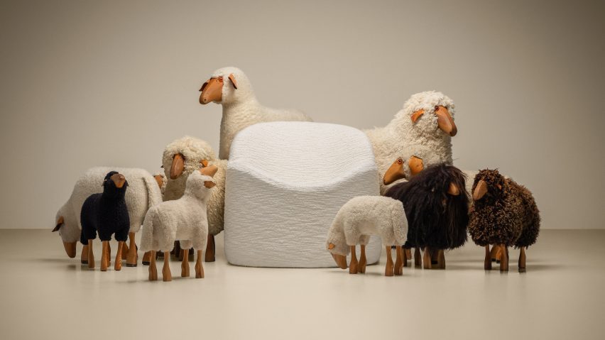 Model sheep next to a fluffy chair