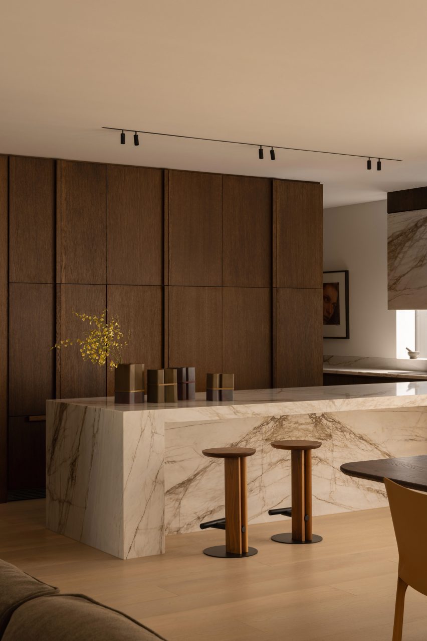Stone kitchen island with wooden stools in front