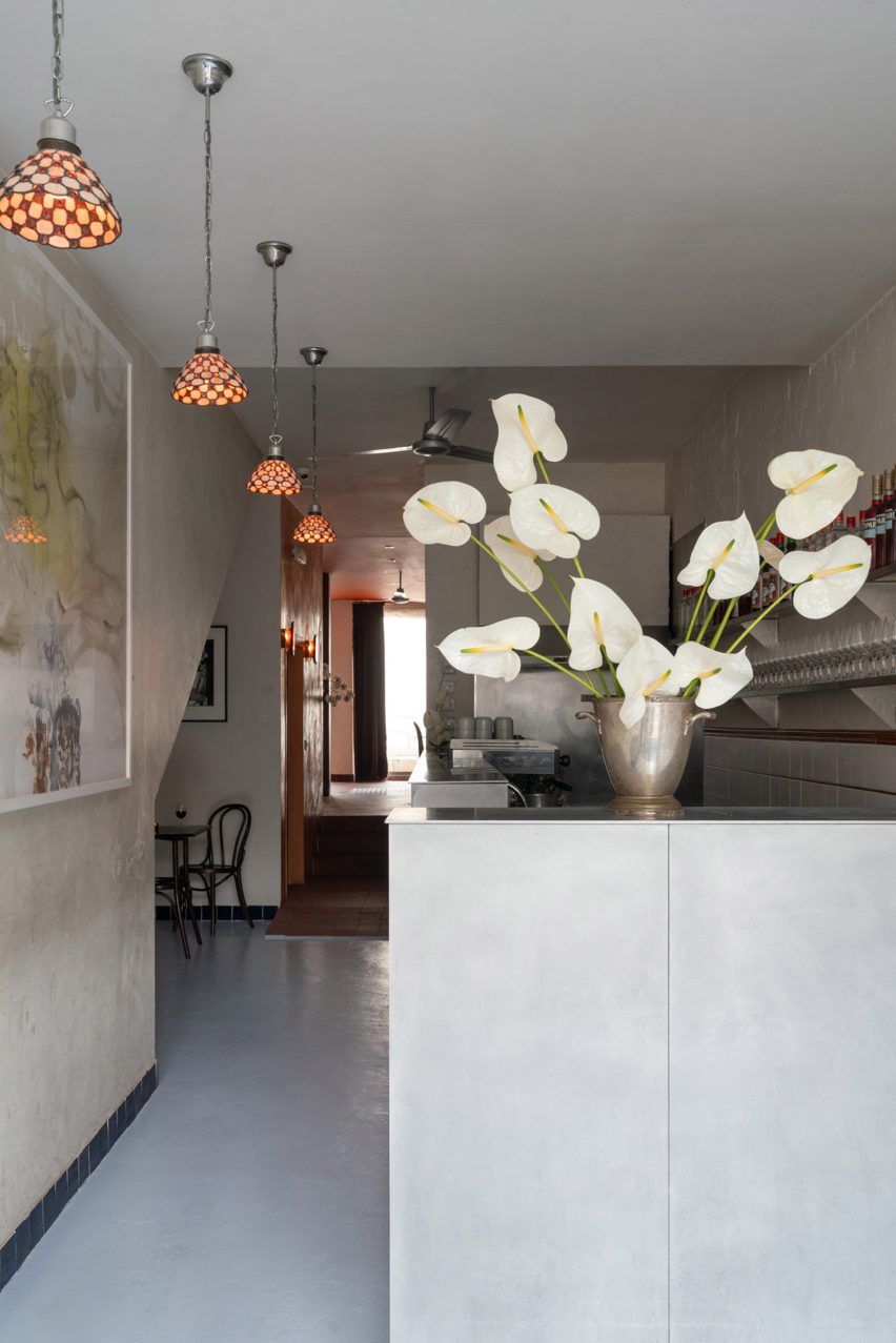 Bar interior with aluminium bar and vase of flowers