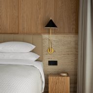 Bedroom with travertine and wood headboard