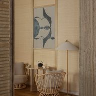 Rattan chair and black and white artwork